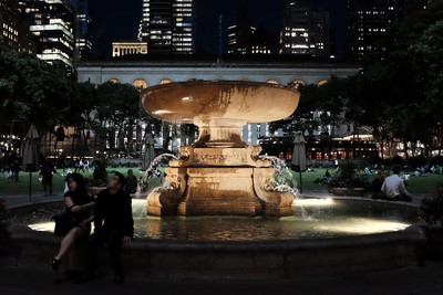 Chilling at night beside the Bryant Park fountain.